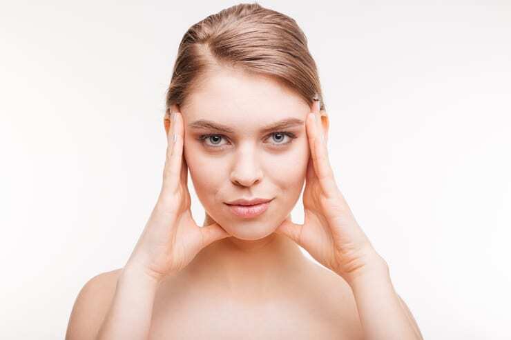 Cute woman with fresh skin looking at camera