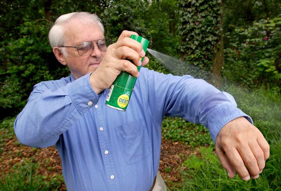 15764-a-man-spraying-insect-spray-on-his-shirt-pv